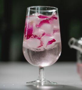 glass of refreshing drink with petals
