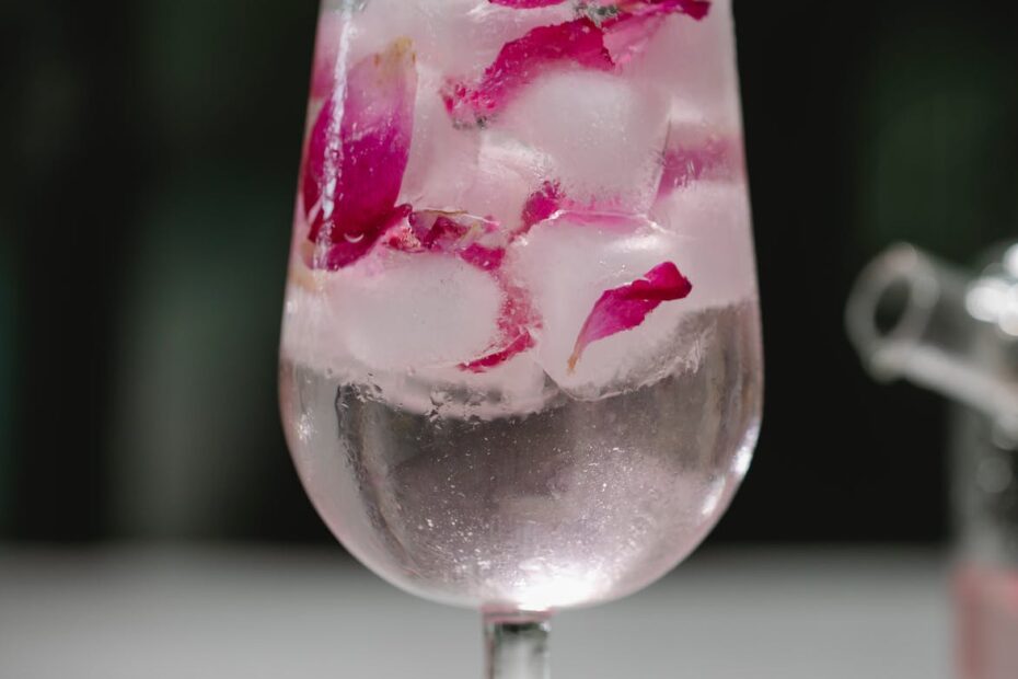 glass of refreshing drink with petals