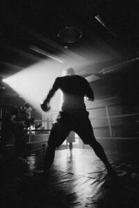 grayscale photo of man in white shirt and black pants