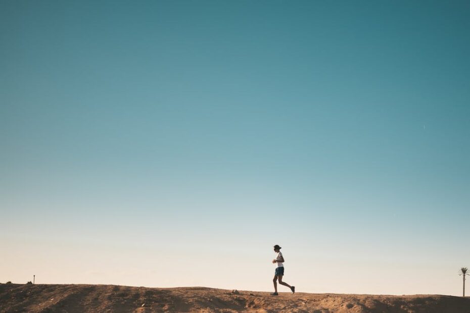 photo of person running on dirt road